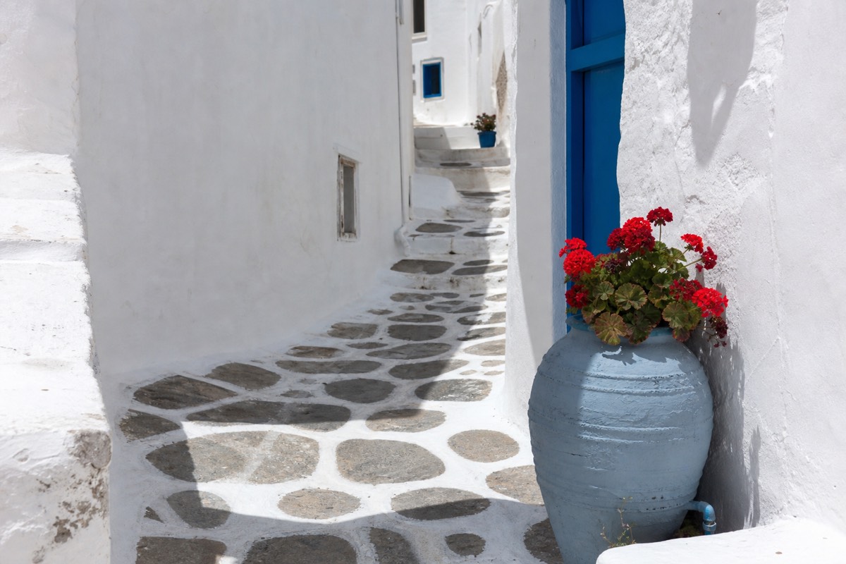 A near-empty whitewashed island lane during the quiet low season